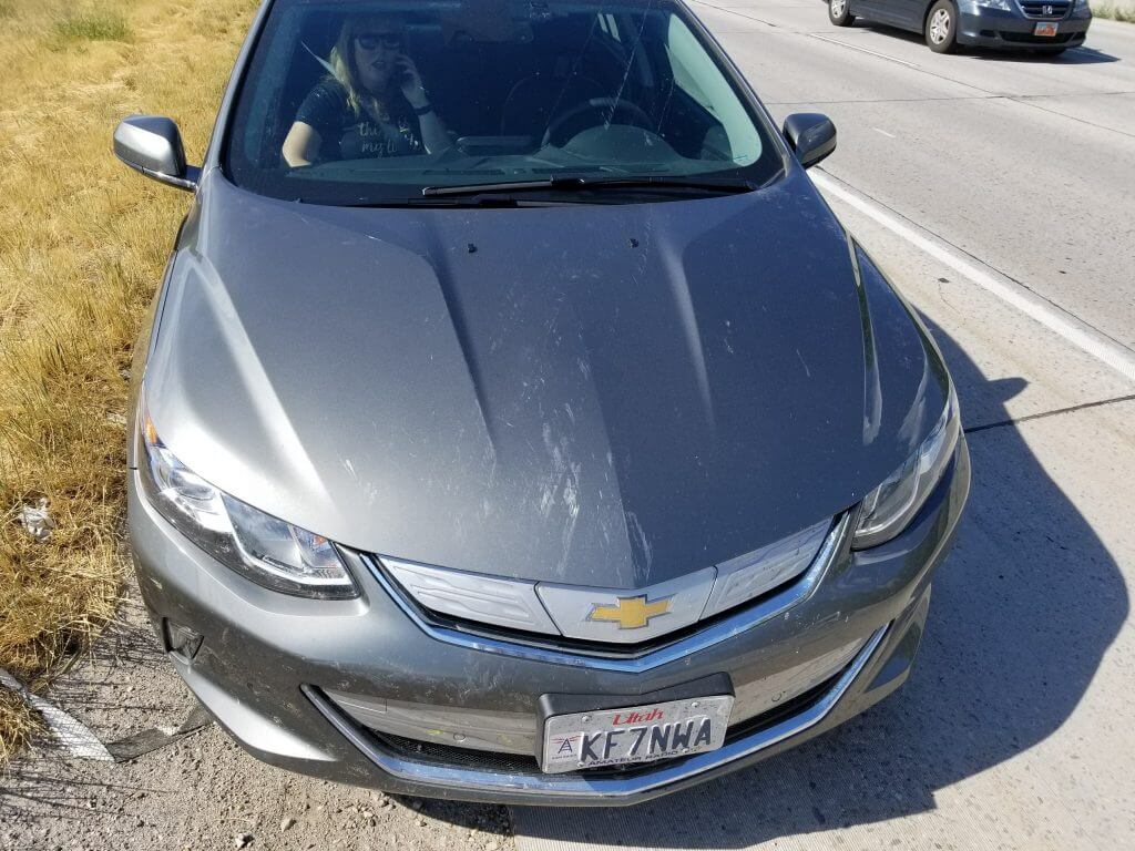 Damage to the front bumper, grill, hood, and windshield.
